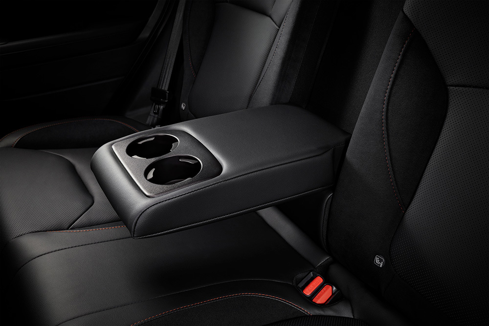 Nedfældet armlæn mellem bagsæderne i Subaru Forester med integrerede kopholdere.